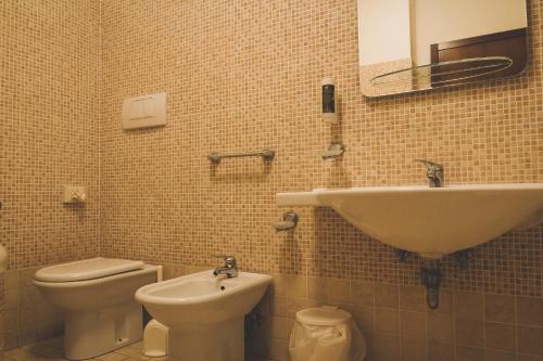 a bathroom with a sink and a toilet and a mirror at Agriturismo Le Francesche in Nocera Umbra