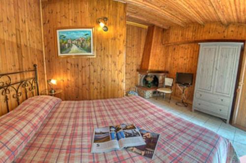 a bedroom with a bed with two books on it at Villa dei Pini in Pescasseroli