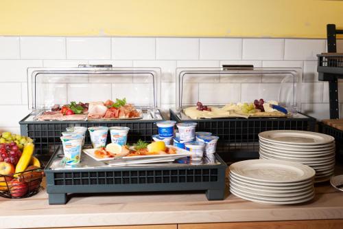 a kitchen with two trays of food and plates at Hotel Gasthof zur Post in Obernberg am Inn