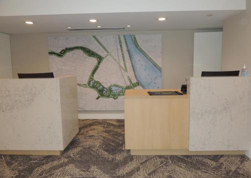 an office with two desks and a map on the wall at The Inn at Longwood Medical in Boston