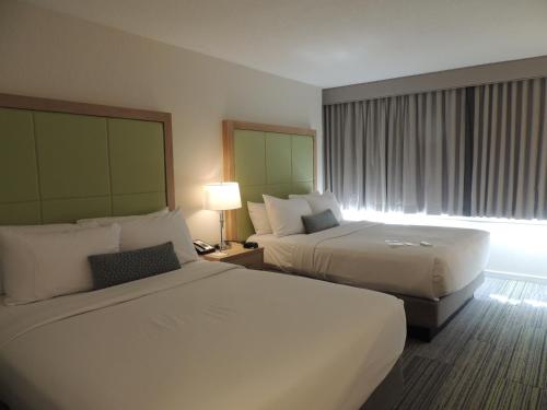 a hotel room with two beds and a window at The Inn at Longwood Medical in Boston