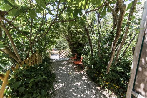 a garden with a bench and trees and a fence at Bastide de Ganay - Saint Jérôme in Aix-en-Provence