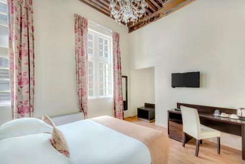 Ένα ή περισσότερα κρεβάτια σε δωμάτιο στο Best Western Marquis de la Baume