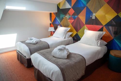 Postel nebo postele na pokoji v ubytování Appart Hôtel Clément Ader