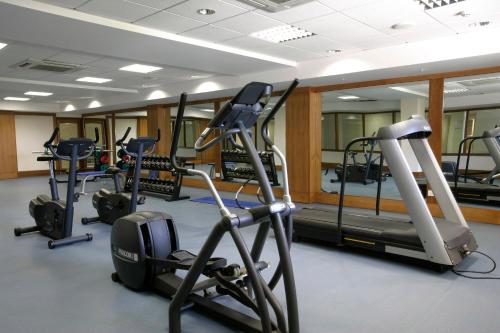 a gym with several treadmills and elliptical machines at Avanti Holiday Village in Paphos