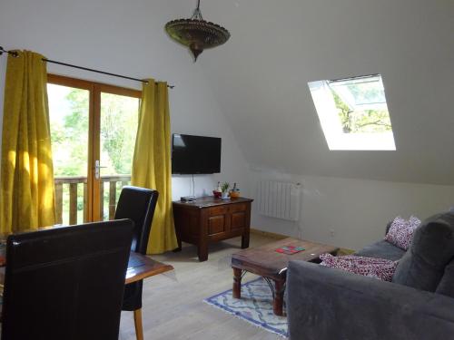 a living room with a couch and a table at Le Pic de Pan - Auberge & Gîtes in Arrens-Marsous