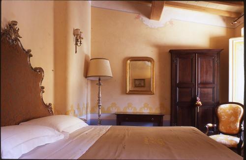 a bedroom with a large bed and a mirror at Locanda Pietrasantese B&B in Pietrasanta