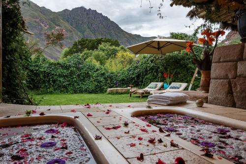 a bath tub filled with lots of flower petals at Pisac Inn in Pisac