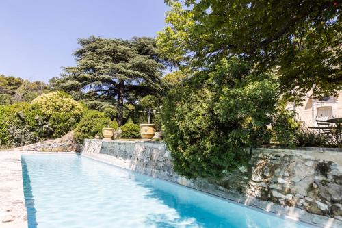 a swimming pool in a yard with trees at Bastide de Ganay - Saint Jérôme in Aix-en-Provence