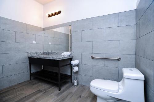 ein Bad mit einem WC und einem Waschbecken in der Unterkunft Hotel Robledal in Alajuela