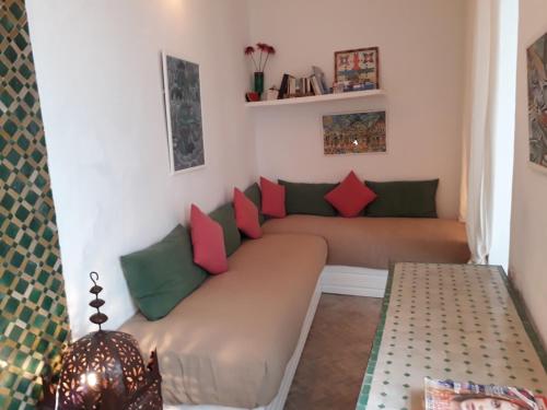 a small room with a couch with pillows on it at Dar es Salam-Baja in Asilah