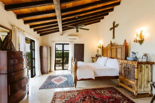 a bedroom with a bed and a dresser in a room at Hacienda San Angel in Puerto Vallarta