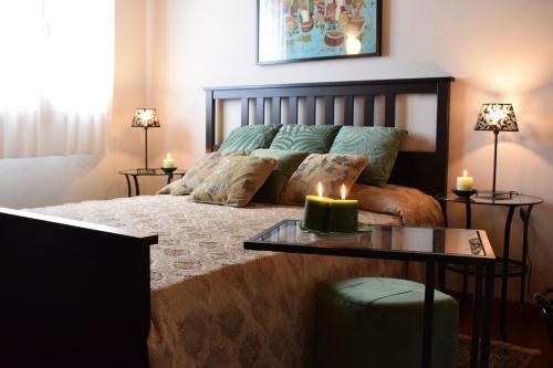 a bedroom with a bed with two candles on it at B&b Ca'Baracca Bellavista in Bassano del Grappa