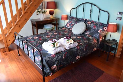 a bedroom with a bed with two dolls on it at B&b Ca'Baracca Bellavista in Bassano del Grappa