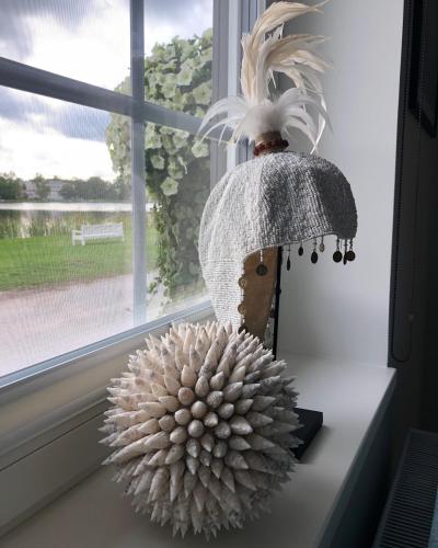 a lamp sitting on a window sill next to a pompom at Viigi Villa in Haapsalu
