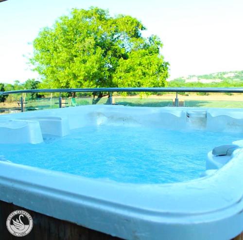 a large hot tub with blue water in it at Hotel Campestre El Cisne in Barranquilla