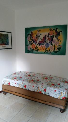 1 cama en una habitación con un cuadro en la pared en G&G2 Appartamento con giardino, en Nonio