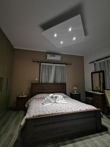 a bedroom with a bed with a robe on it at Kalamospito Holiday House in Kalokhorio