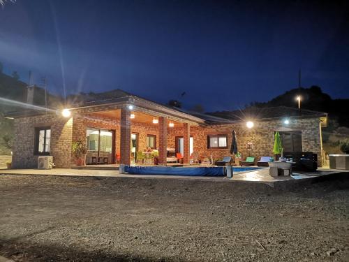 a brick house at night with aphalt at Kalamospito Holiday House in Kalokhorio