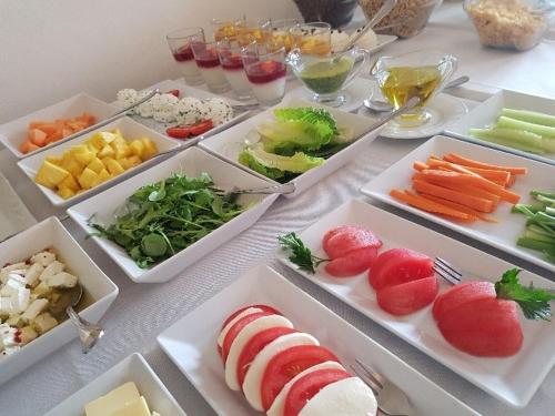 a table topped with trays of different types of food at Da Vinci in Chęciny