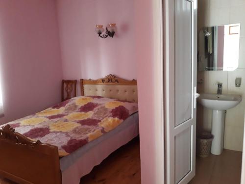 a small bedroom with a bed and a sink at ASINE Dilijan in Dilijan