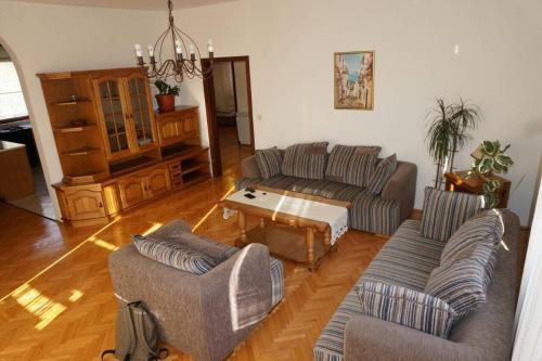 a living room with two couches and a coffee table at Apartments Dolarevic in Sarajevo