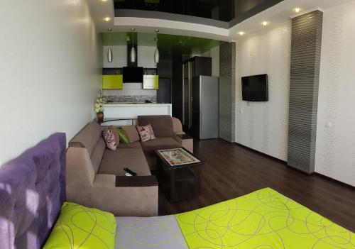a living room with a couch and a table at Апартаменты на 25 этаже. in Kharkiv