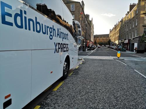 a bus parked on the side of a city street at aabAlree Guest House in Dundee