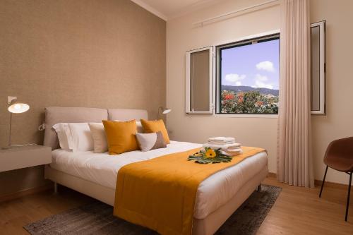 a bedroom with a large bed with a window at Villa Sunrise View by Homie in Santa Cruz
