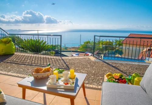 a table with a bowl of fruit on a balcony at Villa Sunrise View by Homie in Santa Cruz