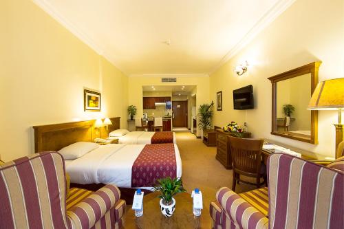 a hotel room with a bed and a living room at Rolla Residence Hotel Apartment in Dubai