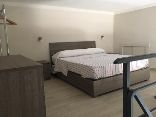 a small bedroom with a bed and a desk at CASA GIULIETTA in Vico Equense