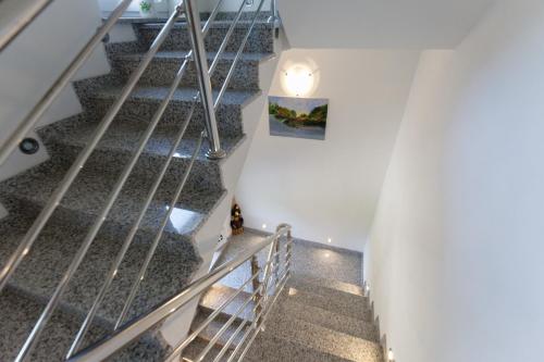 a staircase in a house with metal railings at Apartment Snježana in Slunj