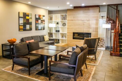 a living room with a couch and a table at Country Inn & Suites by Radisson, Washington Dulles International Airport, VA in Sterling