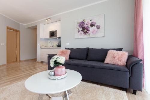 a living room with a blue couch and a white table at Apartment Snježana in Slunj