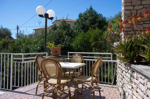 a table and four chairs on a patio at Hotel Cristallo in Lerici