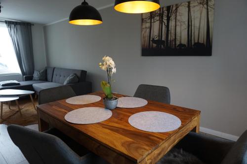 a living room with a wooden table with flowers on it at Ferienhaus Hundertmorgenfeld 33 in Wernigerode