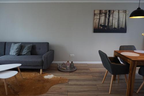 a living room with a couch and a table at Ferienhaus Hundertmorgenfeld 33 in Wernigerode