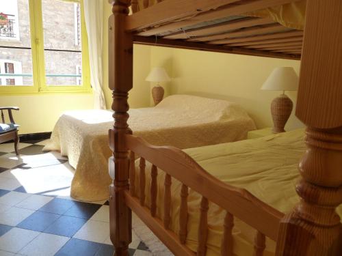 a bedroom with two beds and a large window at Maison Baxter in Prats-de-Mollo-la-Preste
