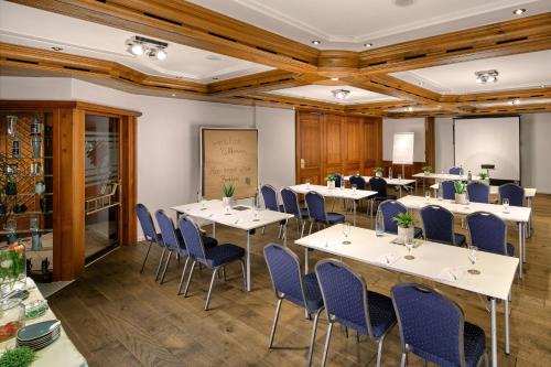 a conference room with tables and blue chairs at Neo Hotel Linde Esslingen in Esslingen
