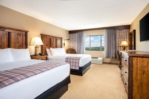 a hotel room with two beds and a window at Lodge of the Ozarks in Branson