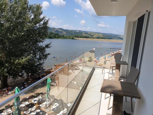 a balcony with a view of a beach and water at Apartman tipa studio BMB in Veliko Gradište