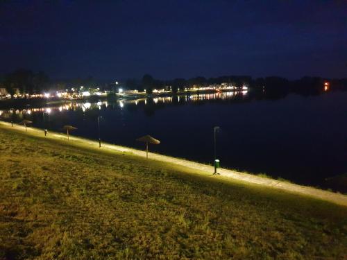 a night view of a river with at Apartman tipa studio BMB in Veliko Gradište