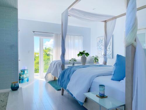 a blue bedroom with a bed with a canopy at Mika's Resort in Colebrooke Dale