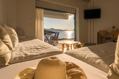 a bedroom with two beds and a view of the ocean at Beach Suite Syrma in Pachaina