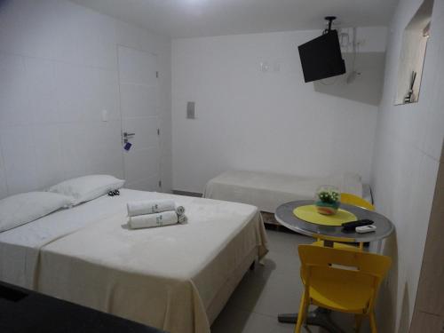 מיטה או מיטות בחדר ב-Apart Marinas Tamandaré