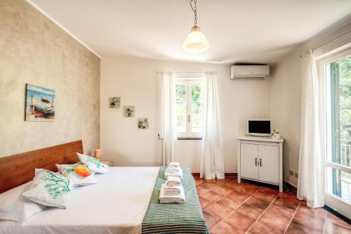 a bedroom with two beds and a television in it at Villa Antonella in Sorrento