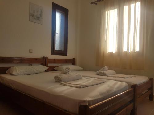two beds in a room with towels on them at Sirocco Apartments in Hersonissos