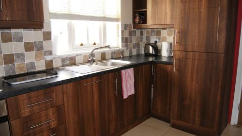 A kitchen or kitchenette at No 9 Seanachaí Holiday Homes Holiday home
