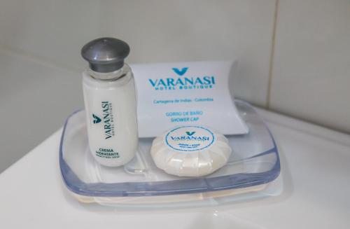 a plastic container with a bottle of shampoo and a bottle of toothpaste at Varanasi Hotel Boutique Aeropuerto in Cartagena de Indias